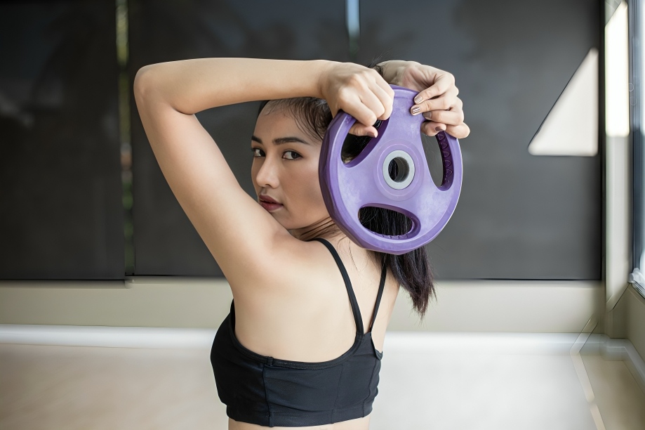Boost Your Body Strength With These 5 Weight Plate Exercises for Women 3 Overhead Presses