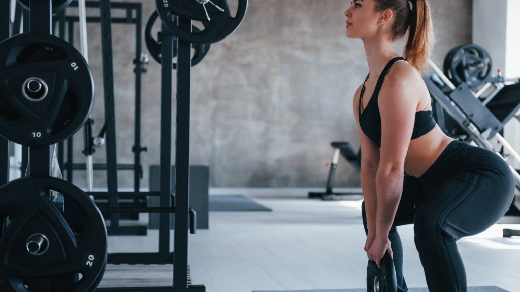 Boost Your Body Strength With These 5 Weight Plate Exercises for Women 2 Weight Plate Squats